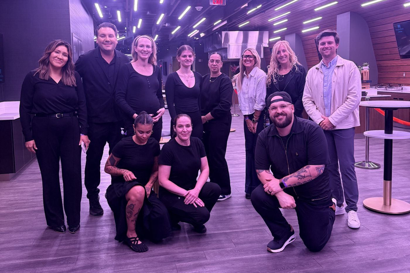Doorbell Barbers team in all black with venue staff at PeoplesBank Arena in Hartford