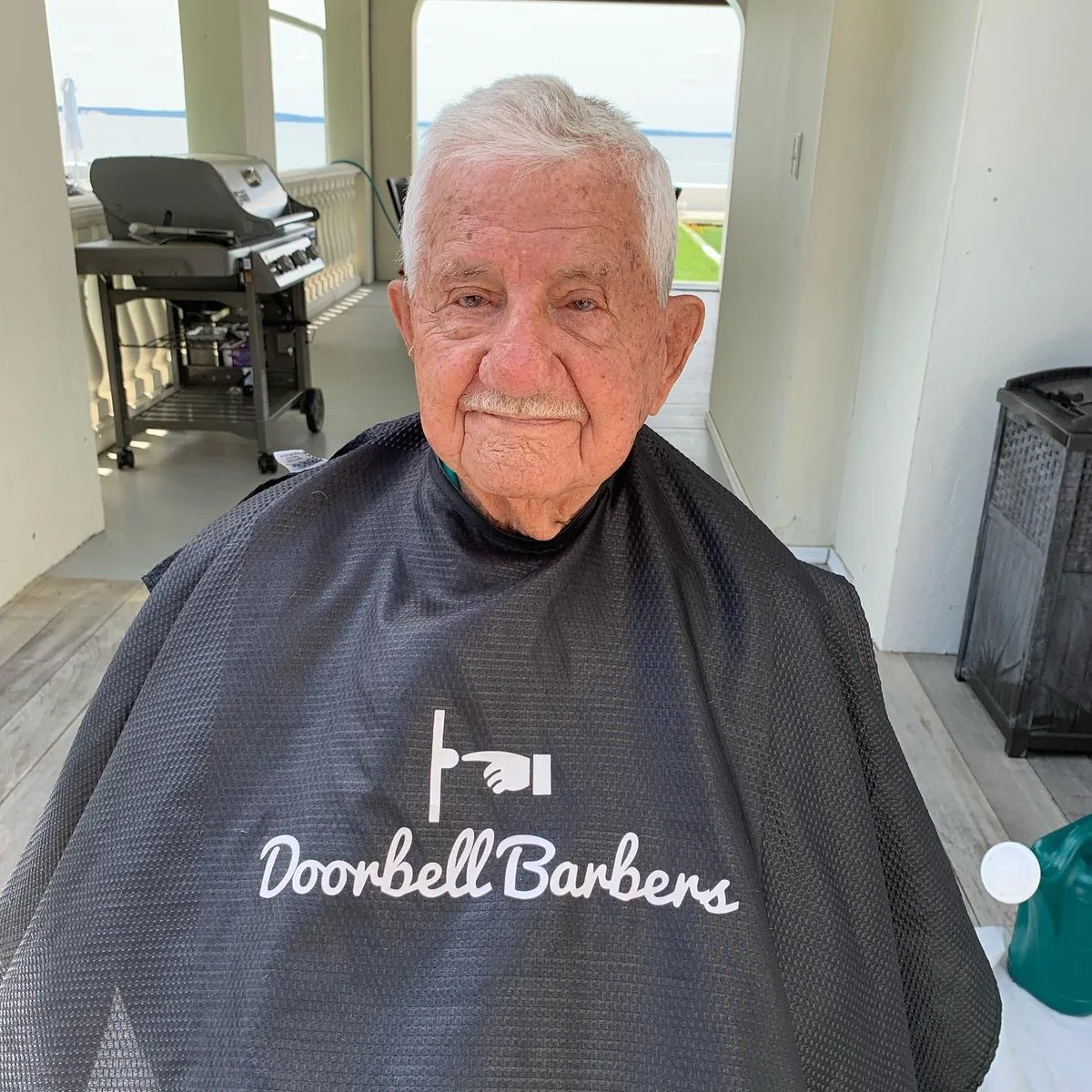 Senior gentleman looking relaxed and happy after a fresh Doorbell Barbers haircut