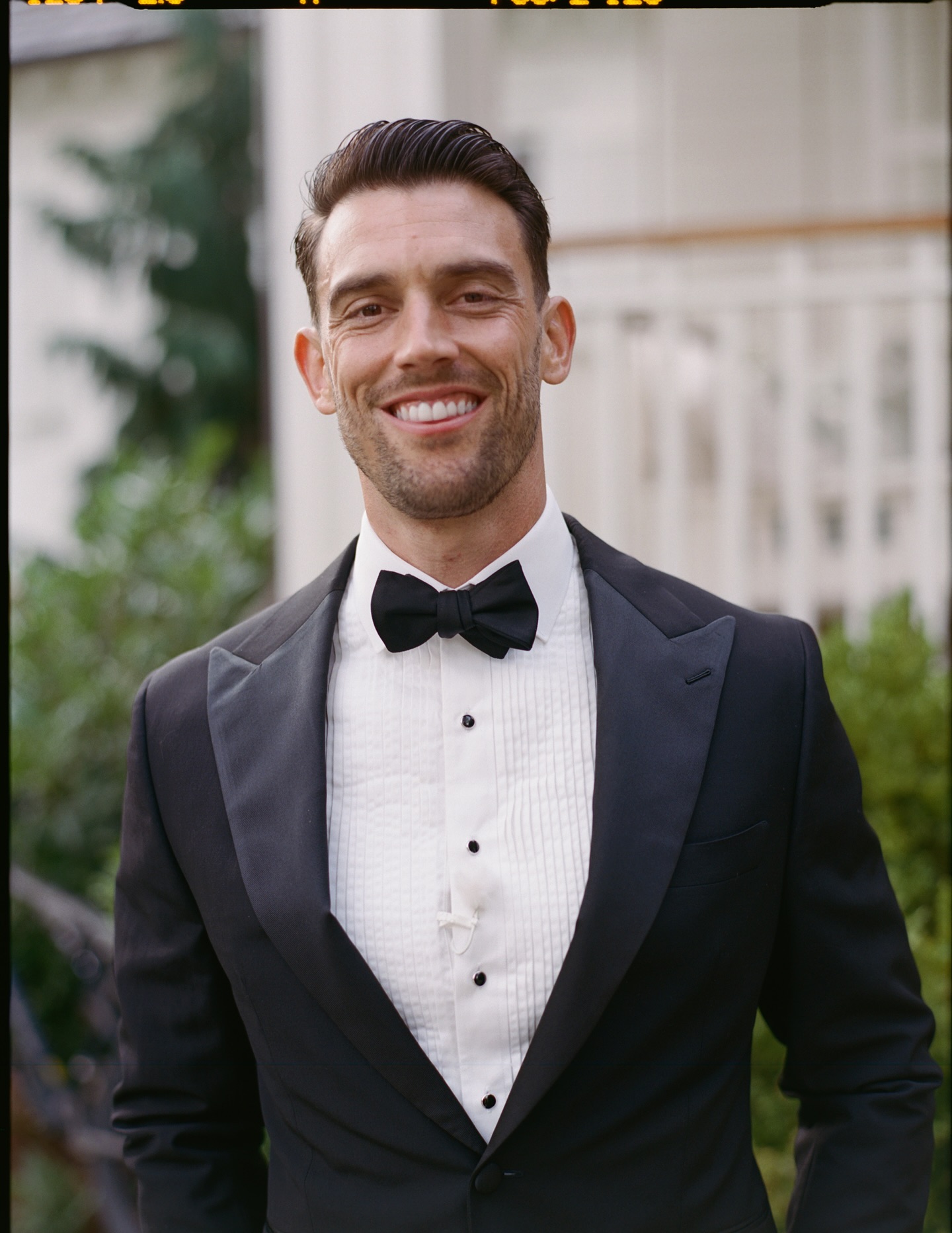 Mike seated in white dinner jacket before the wedding