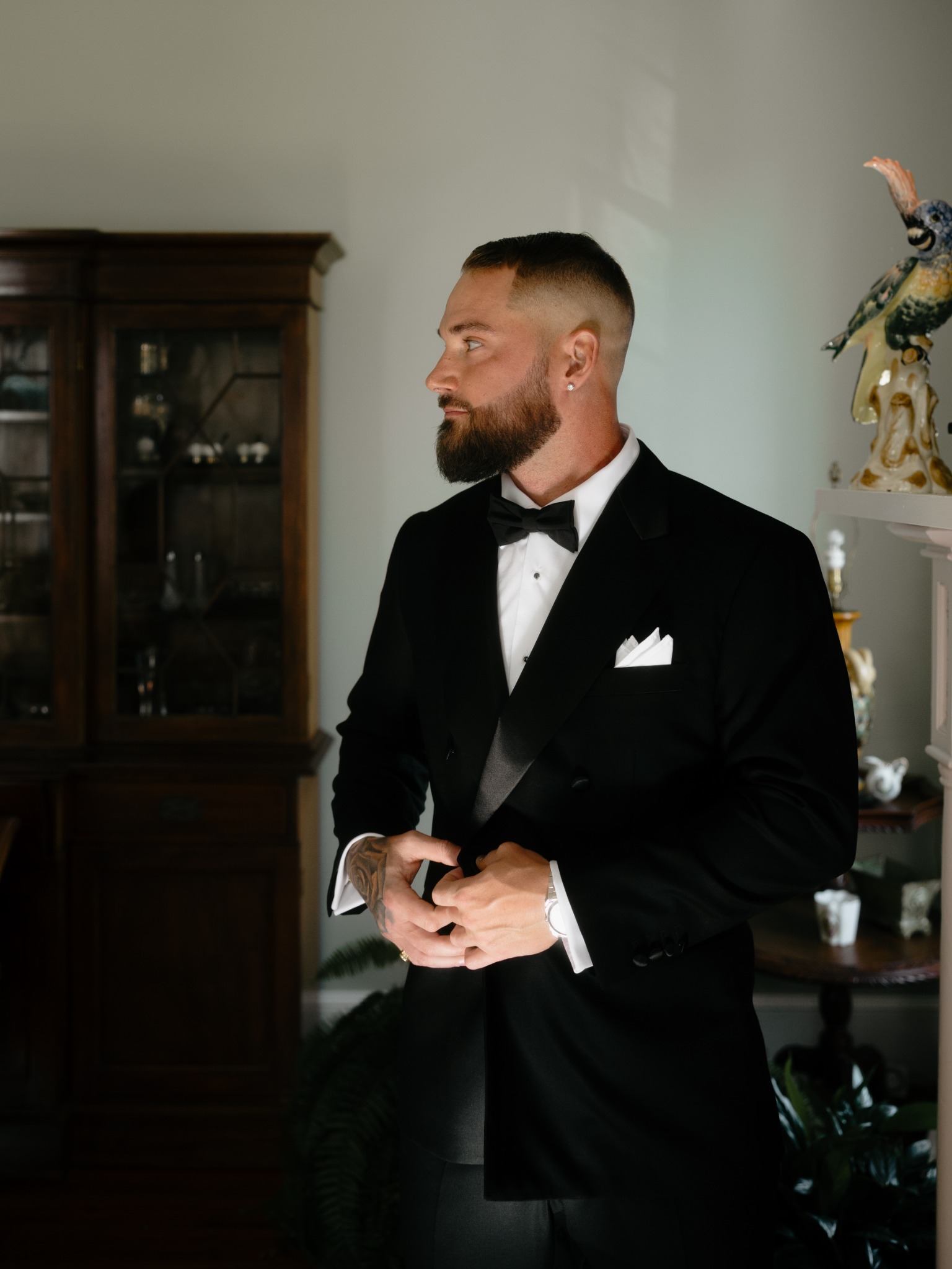 Joe adjusting his tuxedo with boutonniere