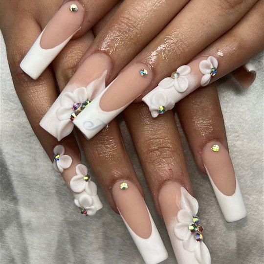 Long square French tip nails with 3D white flowers and crystals by a Doorbell nail technician