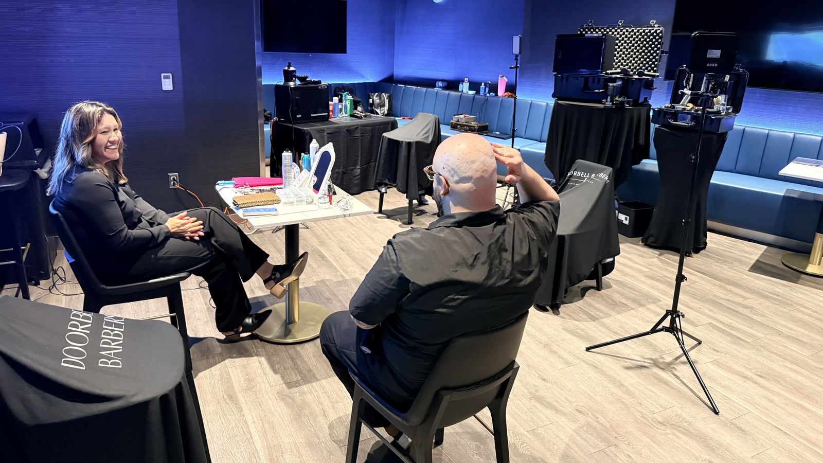 The Doorbell Barbers suite at PeoplesBank Arena set up with branded chair covers, barber stations, tool cases and lighting