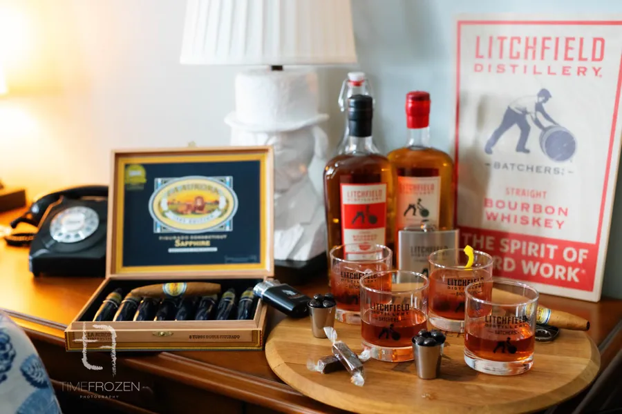 Wedding-morning bourbon and cigar bar with Litchfield Distillery bourbon, rocks glasses and a box of La Aurora cigars
